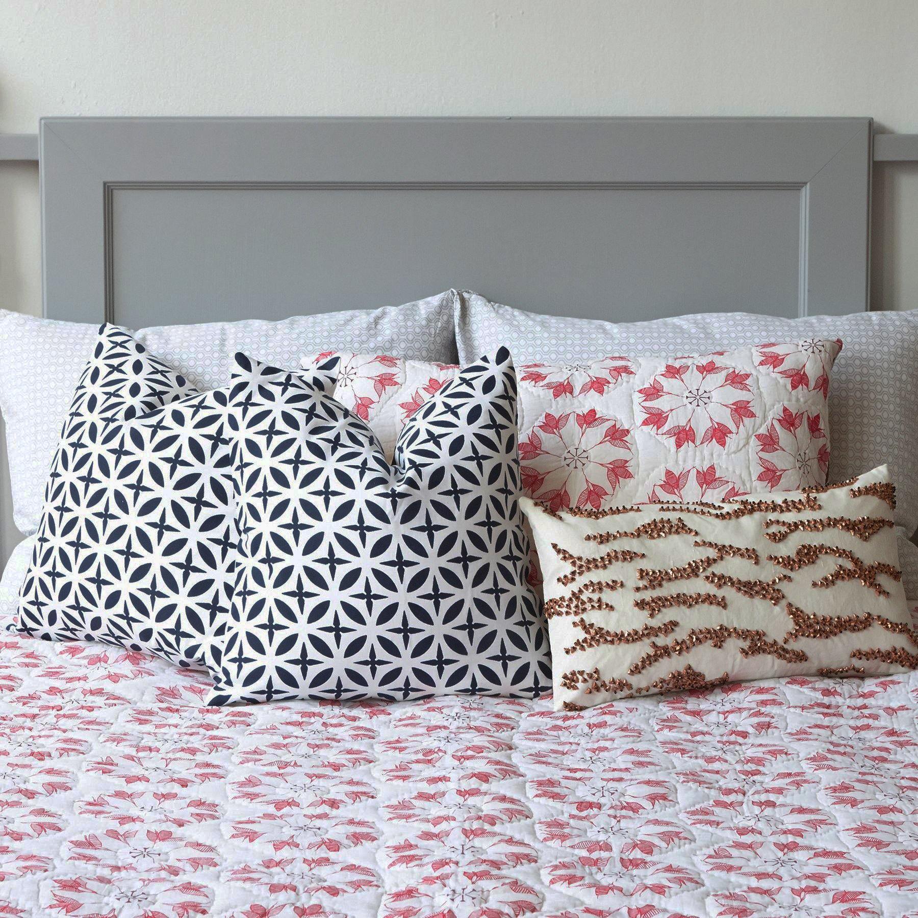 Adelina Quilt by Allem Studio - Round floral pattern of pink and merlot colour on one side. The reverse print has a geometric pattern in a contrast merlot colour.