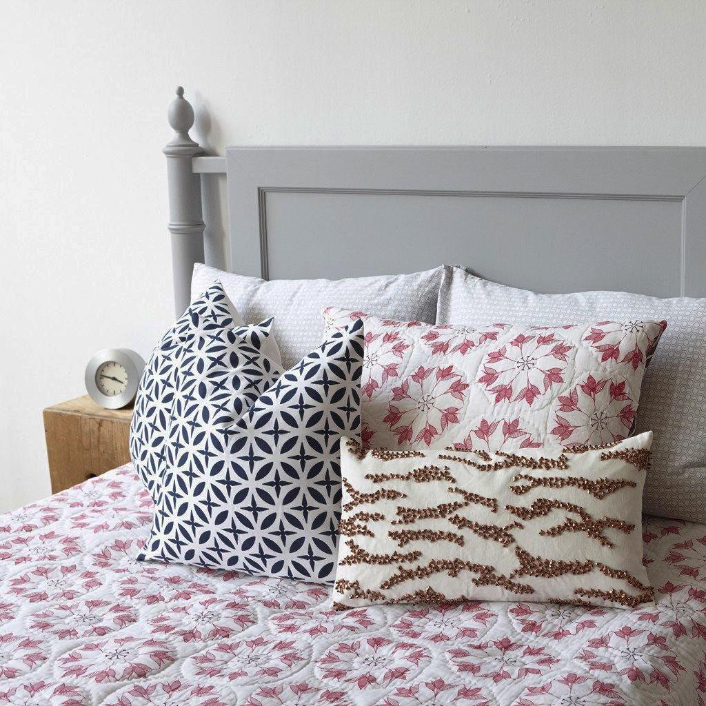 Adelina Quilt by Allem Studio - Round floral pattern of pink and merlot colour on one side. The reverse print has a geometric pattern in a contrast merlot colour.