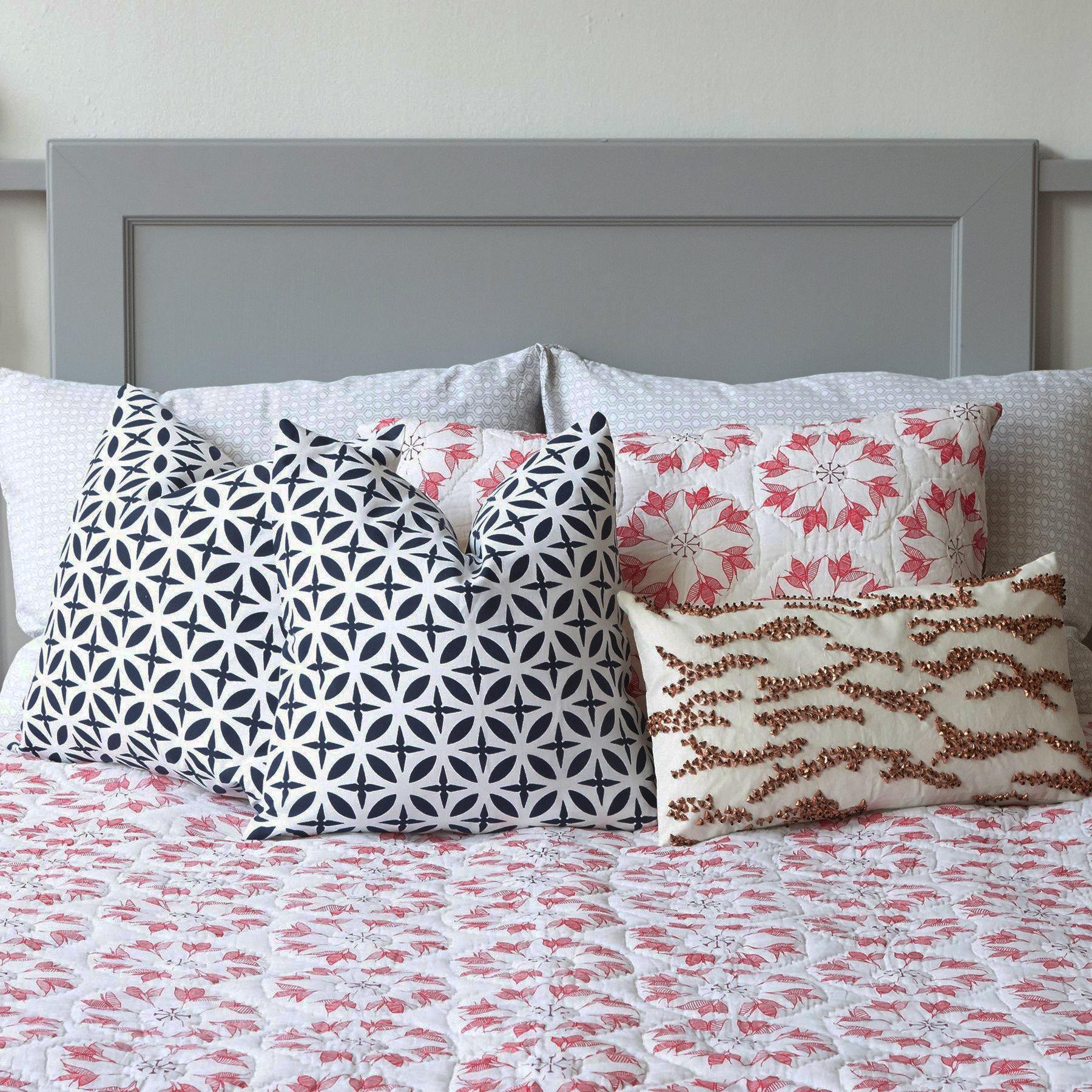 Adelina Quilt by Allem Studio - Round floral pattern of pink and merlot colour on one side. The reverse print has a geometric pattern in a contrast merlot colour. 