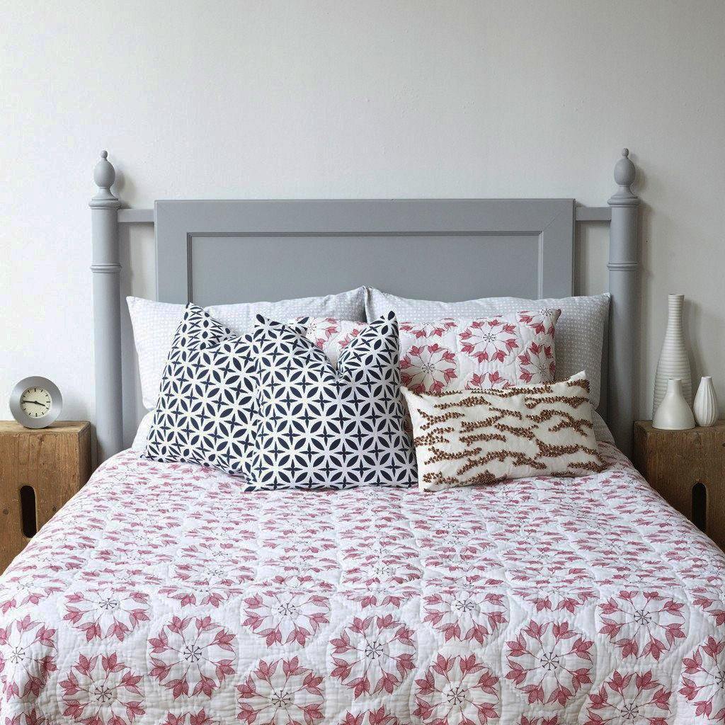 Adelina Quilt by Allem Studio - Round floral pattern of pink and merlot colour on one side. The reverse print has a geometric pattern in a contrast merlot colour. 